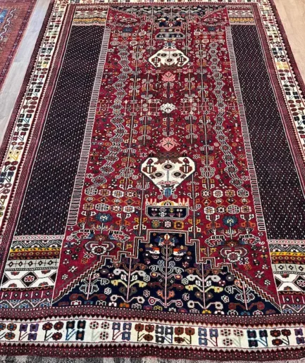 Intricate patterned red Persian rug