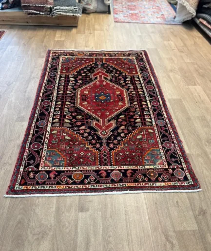 Colourful patterned rug on wooden floor