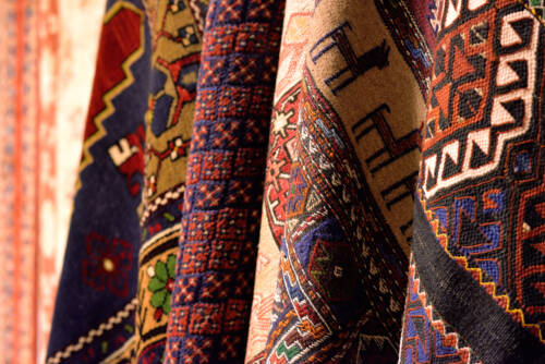 Colourful patterned vintage rugs hanging