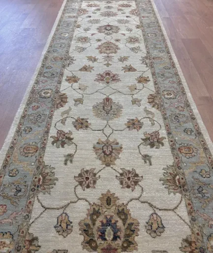 Elegant patterned rug on wooden floor