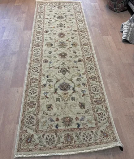 Intricate patterned rug on wooden floor.