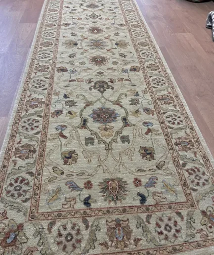 Elegant patterned rug on wooden floor.