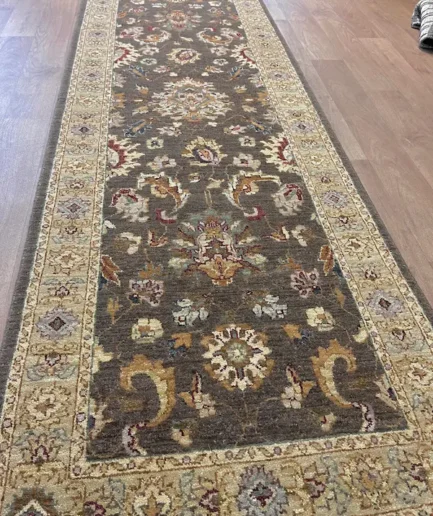 Ornate patterned rug on wooden floor.