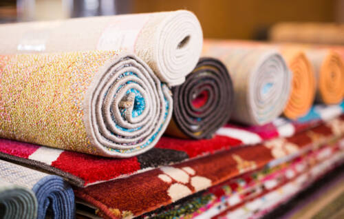 Colourful rolled rugs neatly displayed
