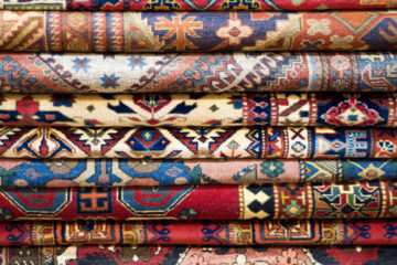 Colourful patterned rugs stacked together, gabbeh rugs UK