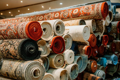 Rolls of decorative rugs stacked neatly
